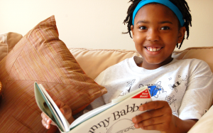 Smiling girl reading book