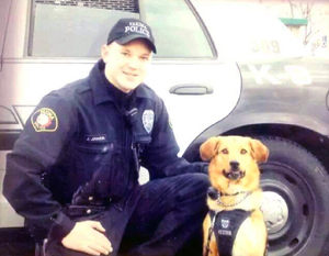 Jason Johnson and his police dog Flash by their patrol car